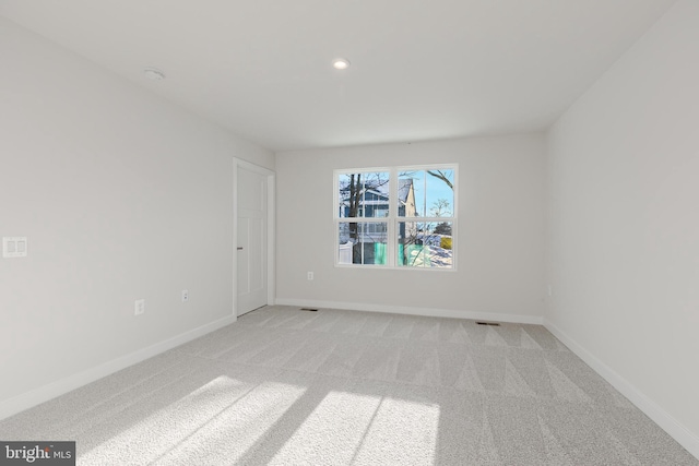 empty room featuring light colored carpet