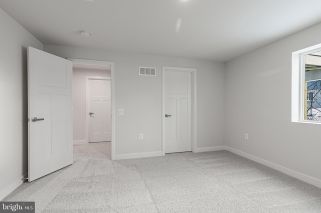 unfurnished bedroom with light carpet