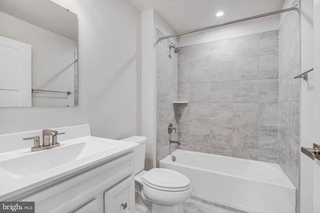 full bathroom featuring vanity, toilet, and tiled shower / bath