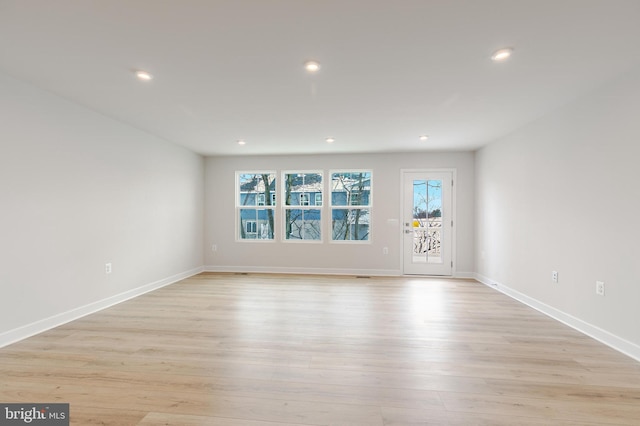 empty room featuring a healthy amount of sunlight and light wood-type flooring