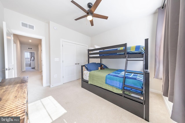 carpeted bedroom featuring baseboards, visible vents, and ceiling fan