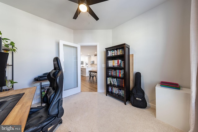 carpeted office space featuring a ceiling fan, french doors, and baseboards