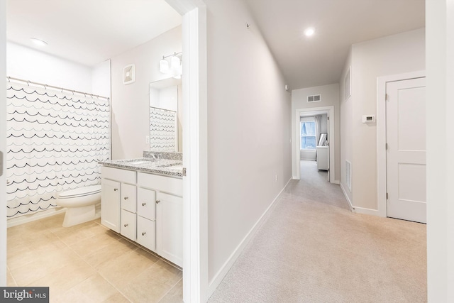 corridor featuring baseboards, recessed lighting, visible vents, and light colored carpet