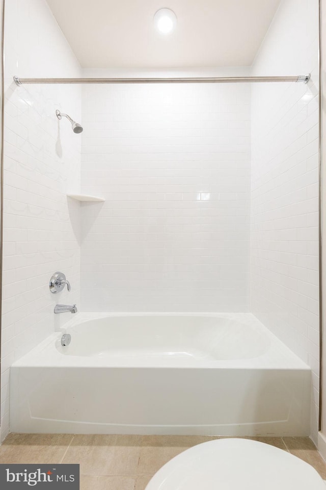 bathroom featuring tile patterned flooring, shower / bathing tub combination, and toilet