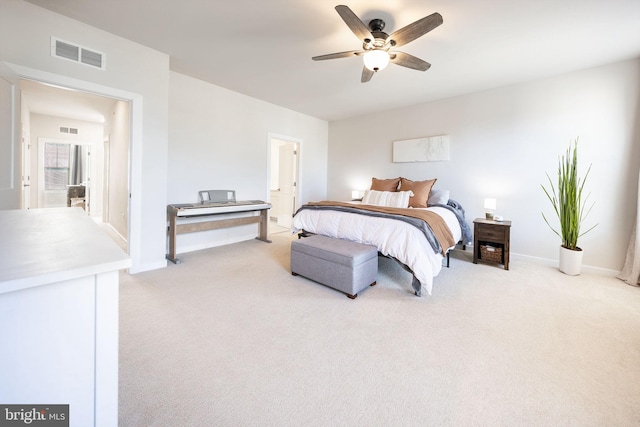 bedroom with light carpet, a ceiling fan, visible vents, and baseboards