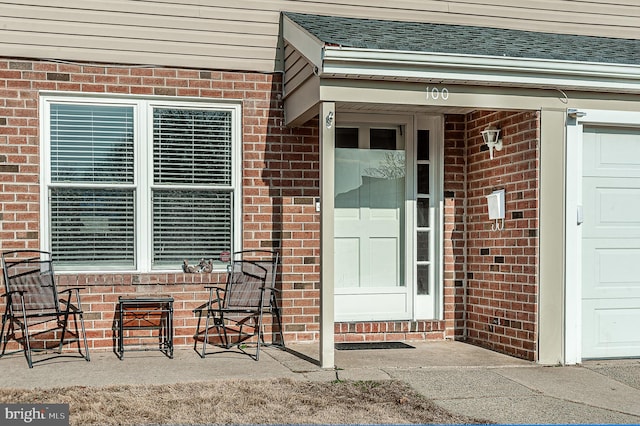 view of exterior entry featuring a garage