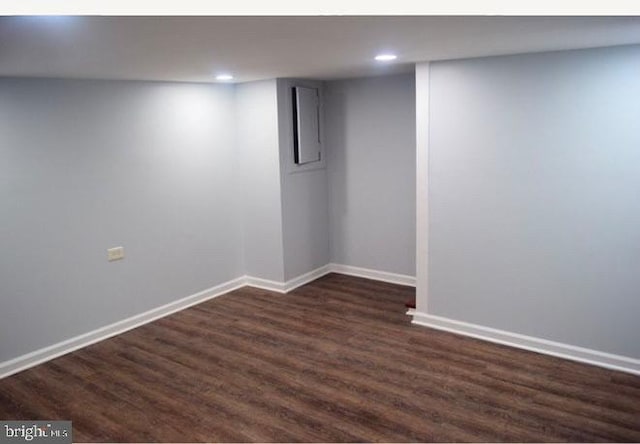 finished below grade area featuring dark wood-style floors, recessed lighting, and baseboards