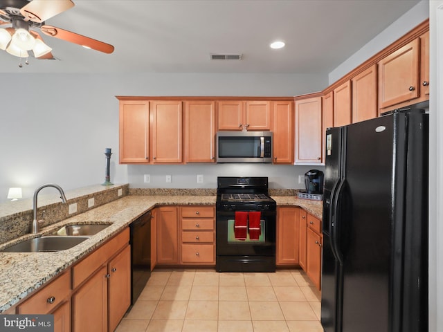 kitchen featuring sink, light tile patterned floors, ceiling fan, black appliances, and light stone countertops