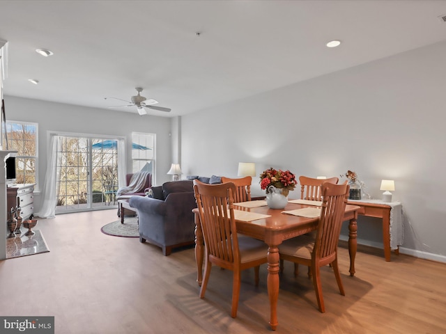 dining space featuring ceiling fan and light hardwood / wood-style flooring