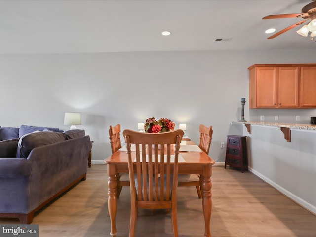 dining area featuring ceiling fan and light wood-type flooring