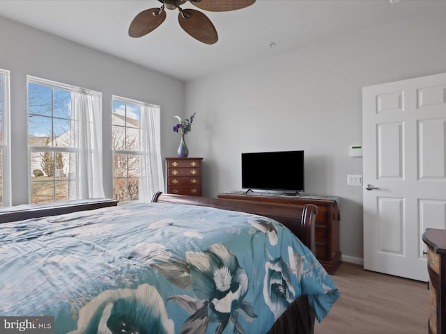 bedroom with ceiling fan and light hardwood / wood-style flooring