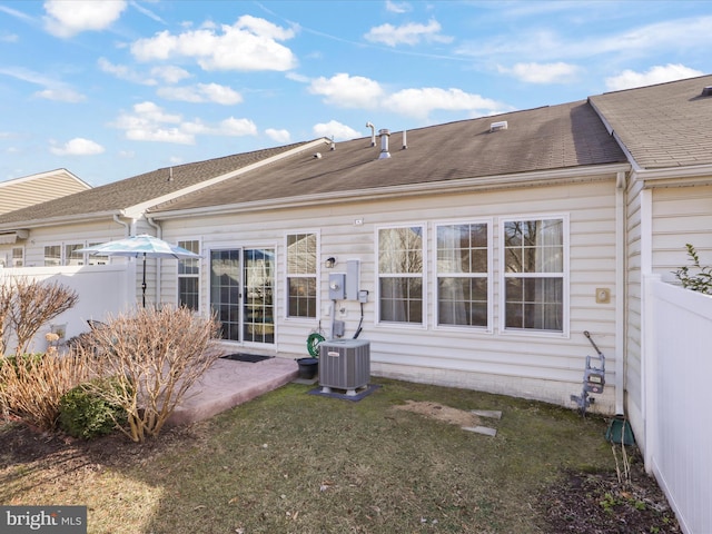 back of property with a patio, a yard, and cooling unit