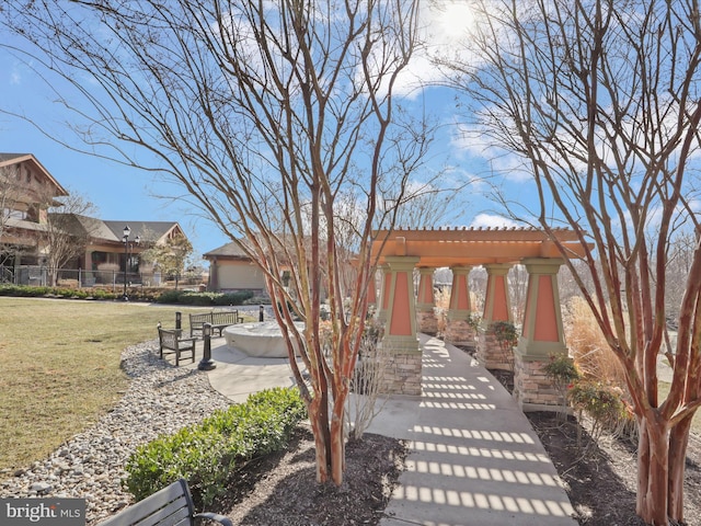 view of home's community with a yard and a pergola