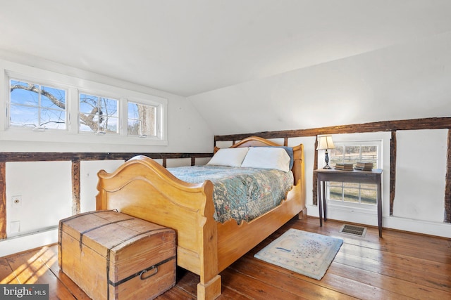 bedroom with vaulted ceiling and dark hardwood / wood-style floors