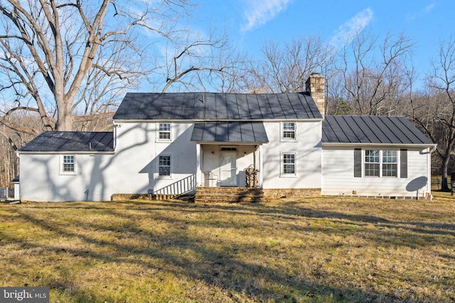 rear view of house with a yard