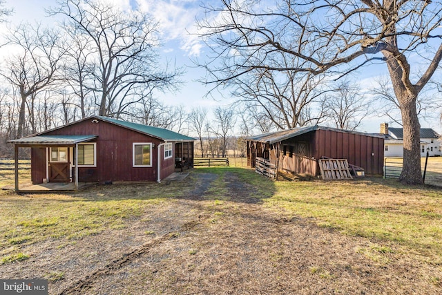 view of home's exterior featuring a yard and an outbuilding