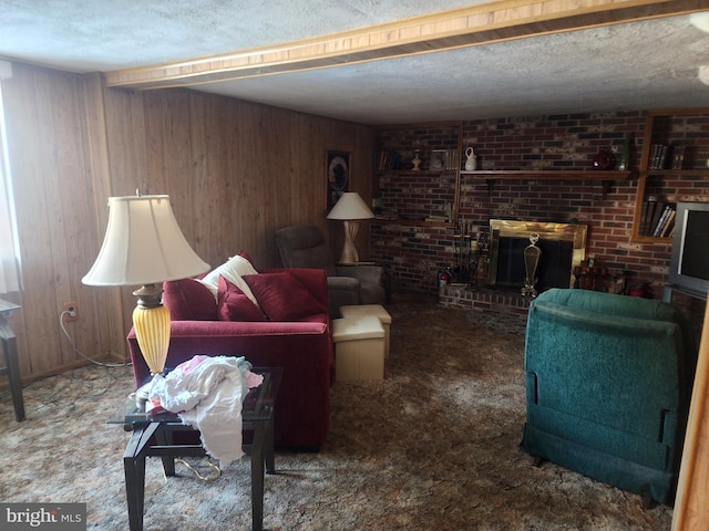 living room featuring a brick fireplace, carpet floors, wooden walls, and a textured ceiling