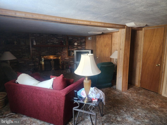 living room featuring carpet flooring, wooden walls, a fireplace, and a textured ceiling