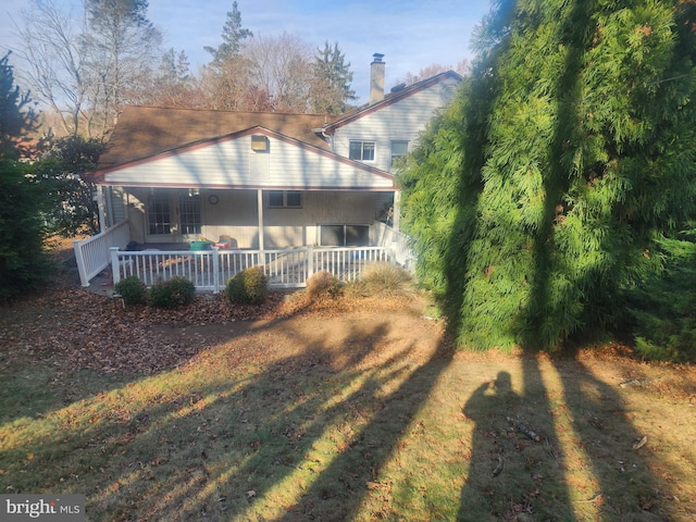 back of property with covered porch