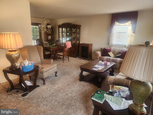 carpeted living room featuring a notable chandelier