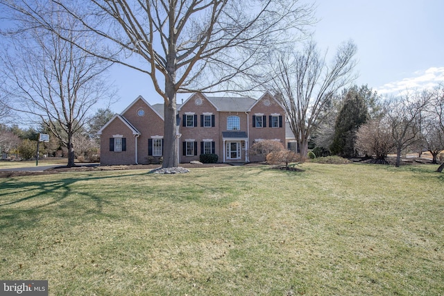 view of front of property with brick siding and a front yard