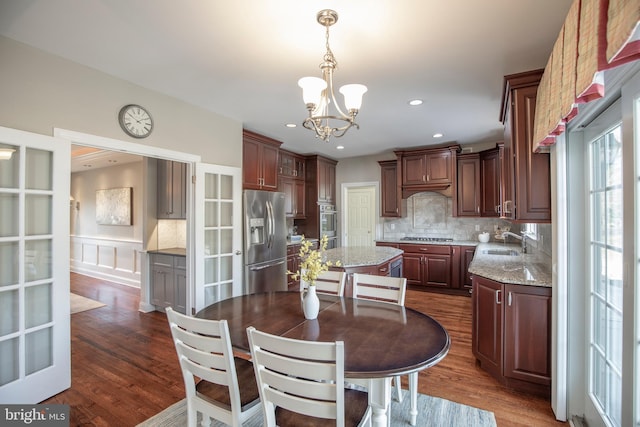 dining area with a chandelier, recessed lighting, and dark wood-type flooring