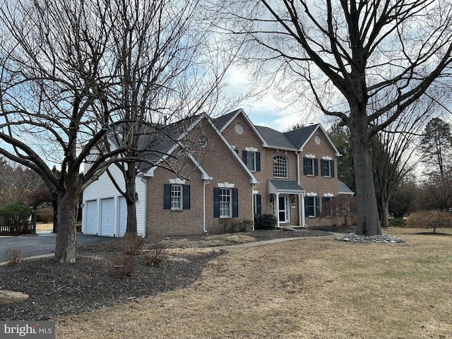 view of front facade with aphalt driveway, brick siding, a garage, and a front lawn