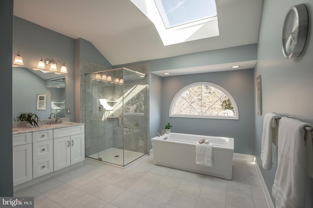 full bathroom with a freestanding tub, lofted ceiling with skylight, a shower stall, tile patterned flooring, and vanity