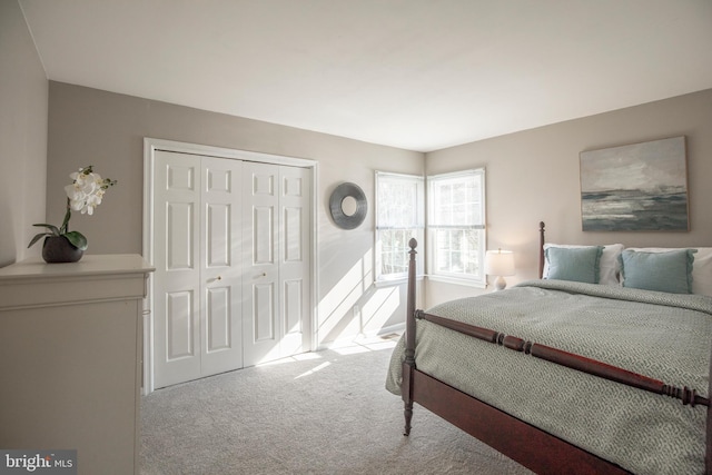 carpeted bedroom with a closet