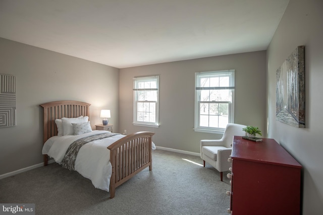 carpeted bedroom featuring baseboards