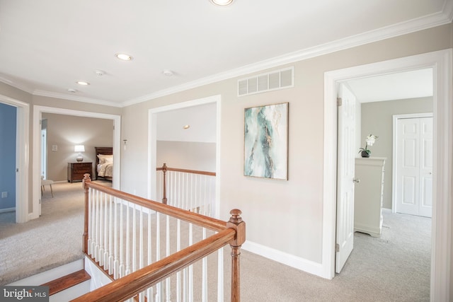 corridor with visible vents, light carpet, an upstairs landing, crown molding, and baseboards