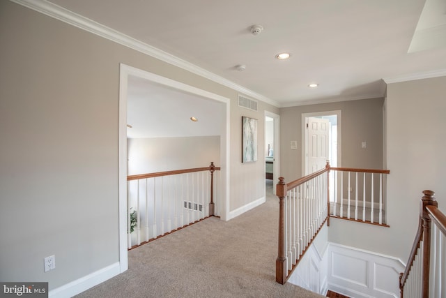 hall featuring crown molding, carpet flooring, an upstairs landing, and visible vents