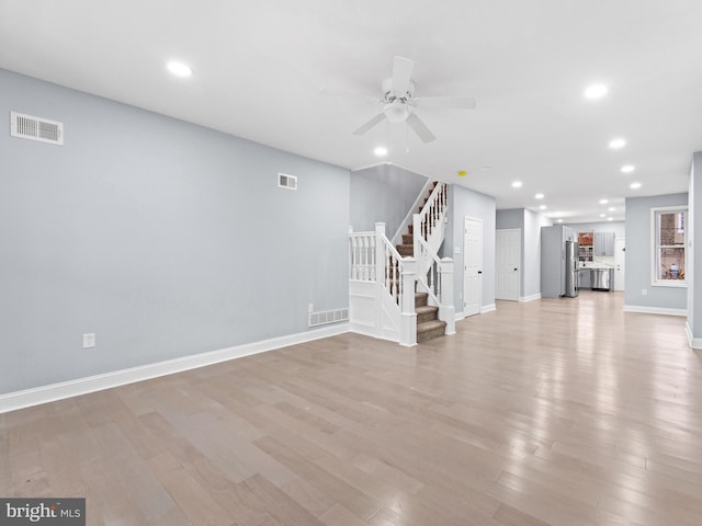 unfurnished living room with ceiling fan and light hardwood / wood-style floors