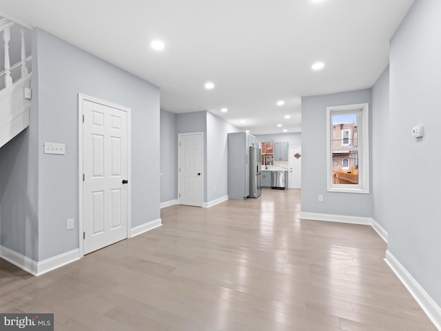 unfurnished living room with light wood-type flooring