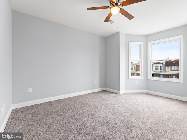 carpeted empty room featuring ceiling fan