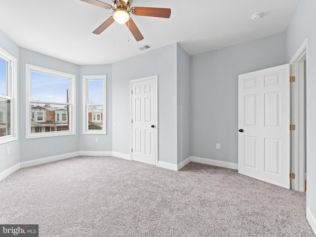 unfurnished bedroom featuring light colored carpet and ceiling fan