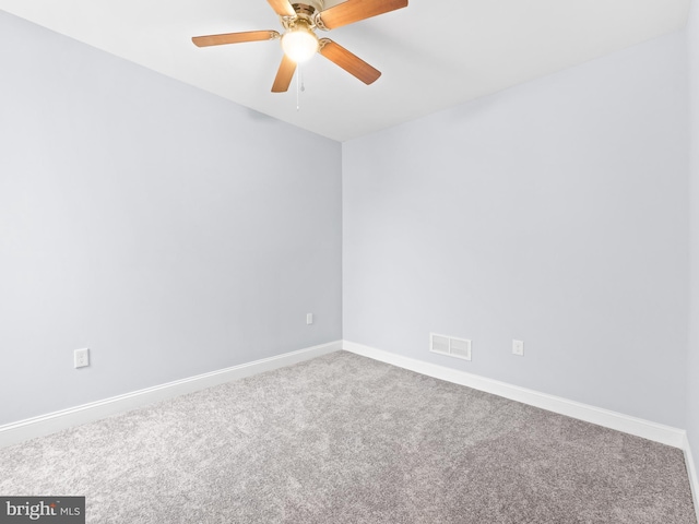 spare room featuring ceiling fan and carpet flooring