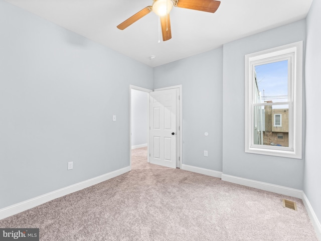 carpeted empty room with ceiling fan