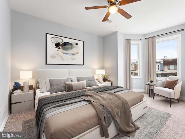 bedroom featuring light carpet and ceiling fan