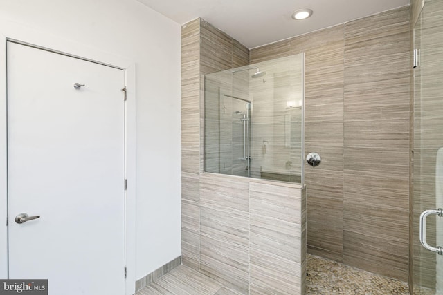 bathroom with a shower with door