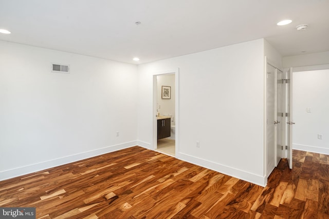 empty room with dark hardwood / wood-style flooring