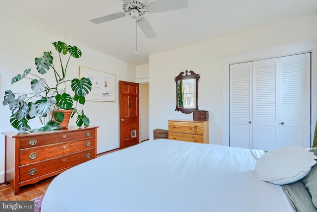 bedroom featuring ceiling fan, a closet, and wood finished floors