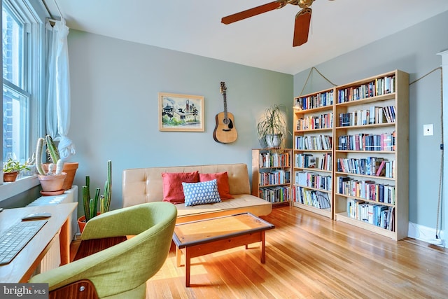 living area featuring wood finished floors and a ceiling fan