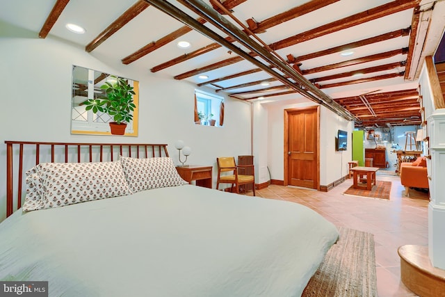 bedroom with light tile patterned floors and baseboards