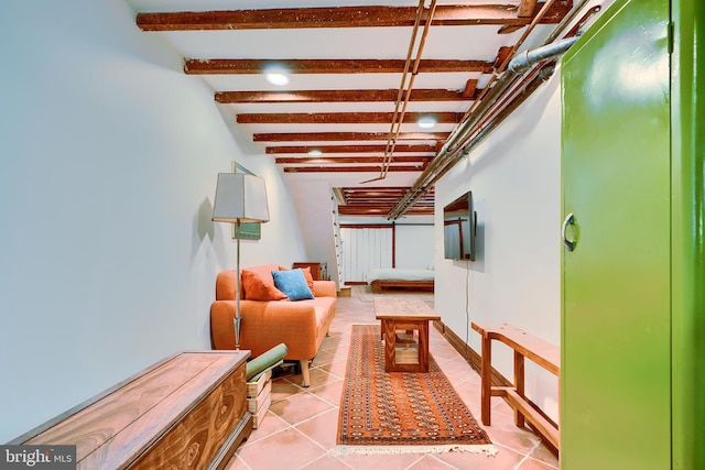 corridor with light tile patterned floors, baseboards, and beam ceiling