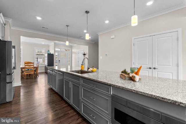 kitchen featuring sink, stainless steel appliances, light stone countertops, dark hardwood / wood-style flooring, and decorative light fixtures