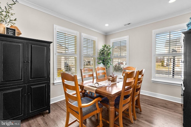 dining room with hardwood / wood-style floors and crown molding