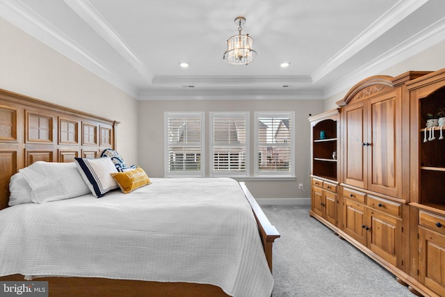 carpeted bedroom with a raised ceiling, crown molding, and a notable chandelier