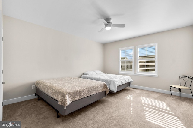 bedroom featuring light colored carpet and ceiling fan