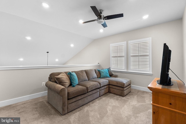 living room with ceiling fan, light colored carpet, and vaulted ceiling